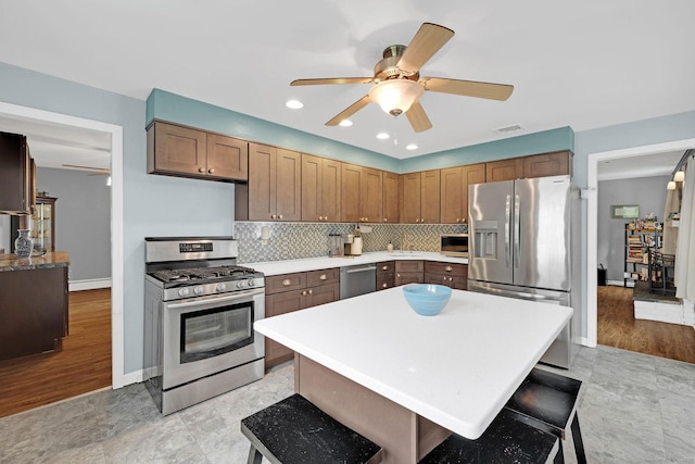 24 Saley Rd, Milford, CT 06460 - kitchen featuring appliances with stainless steel finishes, a ceiling fan, light countertops, tasteful backsplash, and recessed lighting
