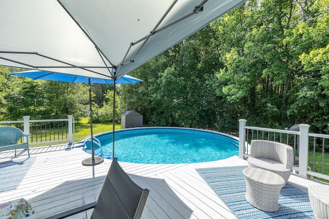24 Saley Rd, Milford, CT 06460 - outdoor pool featuring a wooden deck, a shed, and view of wooded area