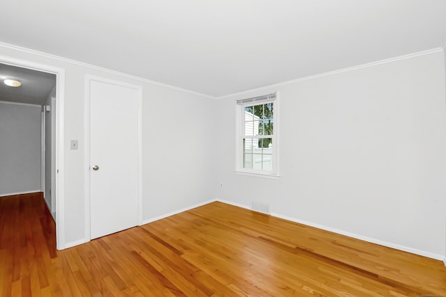 103 Colonial Dr, Fairfield, CT 06824 - unfurnished bedroom featuring wood finished floors, ornamental molding, and a closet