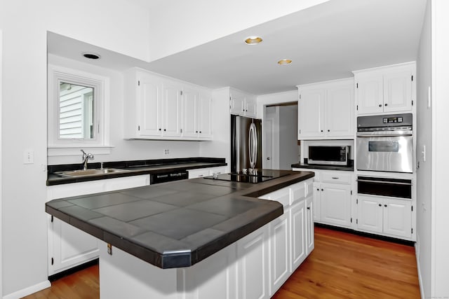 103 Colonial Dr, Fairfield, CT 06824 - kitchen featuring black appliances, a warming drawer, white cabinetry, and recessed lighting