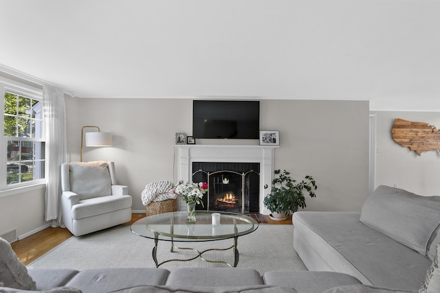 103 Colonial Dr, Fairfield, CT 06824 - living room with a warm lit fireplace and wood finished floors