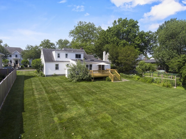 103 Colonial Dr, Fairfield, CT 06824 - back of house featuring a wooden deck and a chimney
