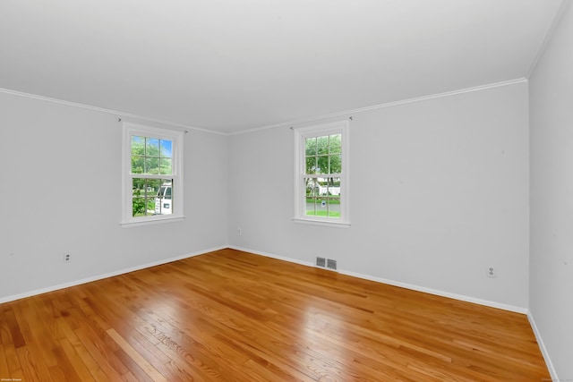 103 Colonial Dr, Fairfield, CT 06824 - empty room featuring light wood-style floors, healthy amount of natural light, and ornamental molding