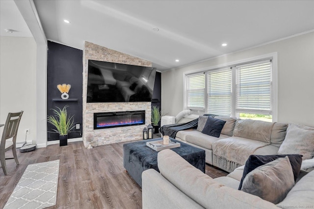 202A Hartford Pike, Foster, Rhode Island, RI 02825 - living area featuring vaulted ceiling, wood finished floors, a stone fireplace, ornamental molding, and recessed lighting