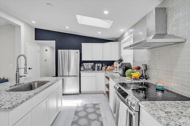 202A Hartford Pike, Foster, Rhode Island, RI 02825 - kitchen featuring appliances with stainless steel finishes, wall chimney exhaust hood, a skylight, tasteful backsplash, and white cabinetry