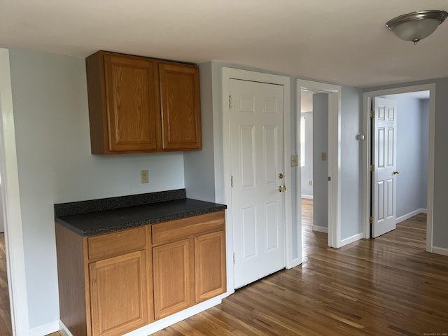 959 First Ave, West Haven, CT 06516 - kitchen featuring dark wood-type flooring, dark countertops, and brown cabinetry