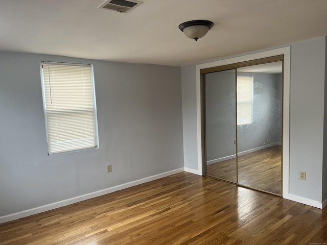 959 First Ave, West Haven, CT 06516 - unfurnished bedroom with wood finished floors and a closet