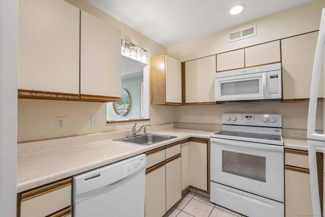 267 Melba St Apt D10, Milford, CT 06460 - kitchen with white appliances, light countertops, light tile patterned flooring, and cream cabinets