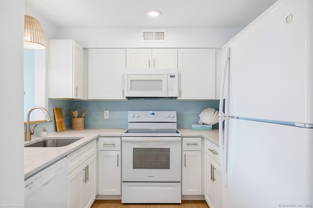 267 Melba St Apt D10, Milford, CT 06460 - kitchen featuring white appliances, light countertops, white cabinetry, and recessed lighting