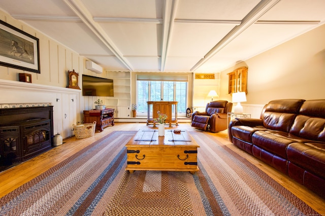 593 Northfield Rd, Watertown, CT 06795 - living room featuring wood finished floors, a wood stove, and built in features