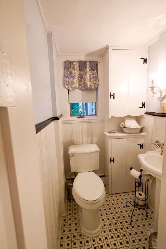 593 Northfield Rd, Watertown, CT 06795 - half bathroom with a wainscoted wall, tile patterned floors, and a baseboard heating unit