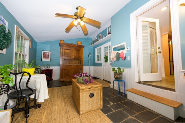 593 Northfield Rd, Watertown, CT 06795 - living area with lofted ceiling, a ceiling fan, a wainscoted wall, and stone finish floors