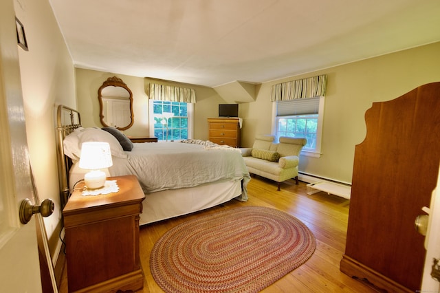 593 Northfield Rd, Watertown, CT 06795 - bedroom featuring multiple windows, wood-type flooring, and a baseboard heating unit