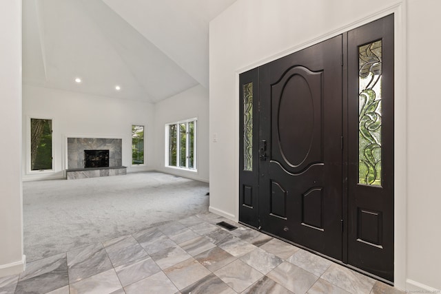 202 High Wood Dr, Glastonbury, CT 06073 - foyer entrance with high vaulted ceiling, light carpet, a fireplace, and recessed lighting