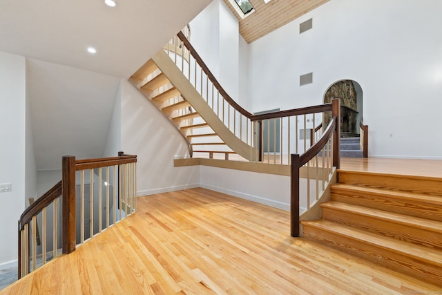 202 High Wood Dr, Glastonbury, CT 06073 - stairway with wood finished floors, high vaulted ceiling, recessed lighting, and arched walkways