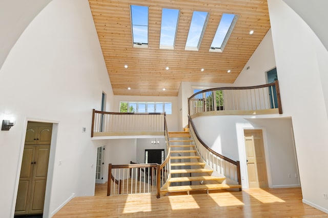 202 High Wood Dr, Glastonbury, CT 06073 - stairway with high vaulted ceiling, wood finished floors, a skylight, and wood ceiling