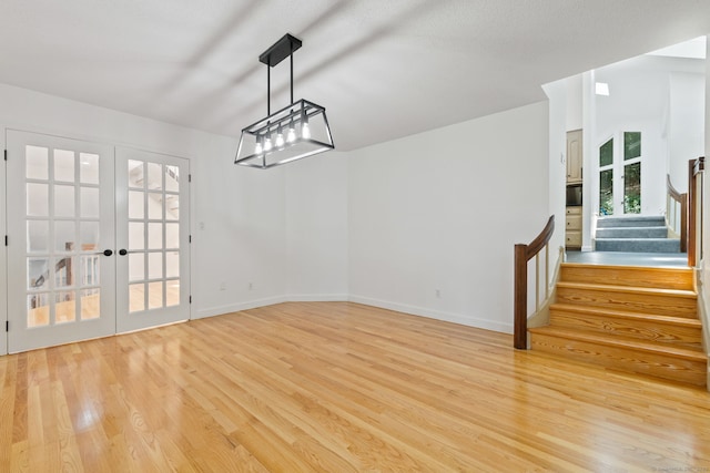 202 High Wood Dr, Glastonbury, CT 06073 - unfurnished dining area featuring light wood finished floors, stairway, and french doors