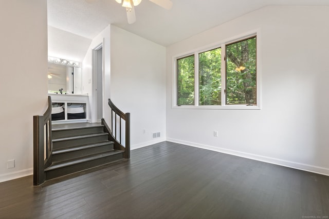 202 High Wood Dr, Glastonbury, CT 06073 - spare room with vaulted ceiling, ceiling fan, dark wood-style floors, and stairs