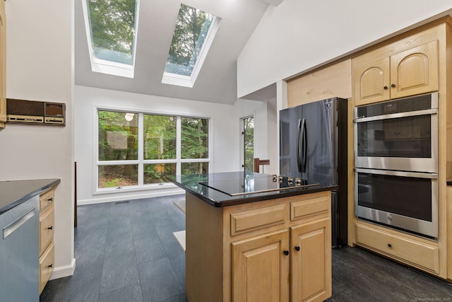 202 High Wood Dr, Glastonbury, CT 06073 - kitchen with stainless steel appliances, light brown cabinetry, lofted ceiling, a skylight, and dark countertops