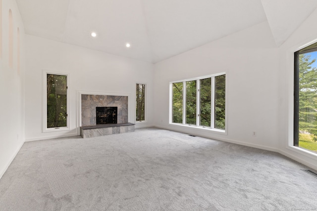 202 High Wood Dr, Glastonbury, CT 06073 - unfurnished living room featuring plenty of natural light, carpet, a tiled fireplace, recessed lighting, and high vaulted ceiling