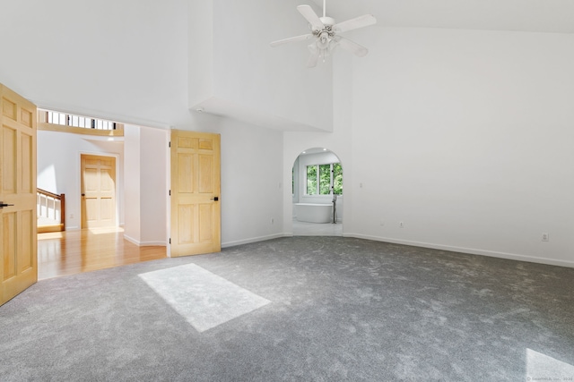 202 High Wood Dr, Glastonbury, CT 06073 - carpeted empty room with a high ceiling, arched walkways, and a ceiling fan