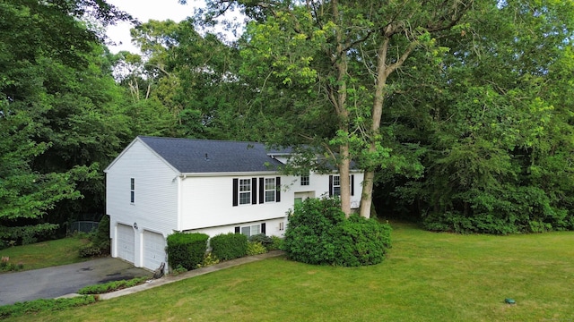 19 Peach Tree Hill Ave, Ledyard, CT 06339 - tri-level home featuring asphalt driveway, an attached garage, a shingled roof, and a front lawn