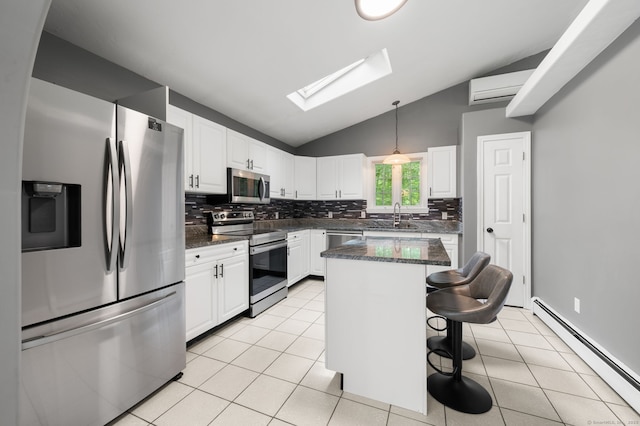 19 Peach Tree Hill Ave, Ledyard, CT 06339 - kitchen featuring appliances with stainless steel finishes, a baseboard radiator, lofted ceiling, decorative backsplash, and a skylight