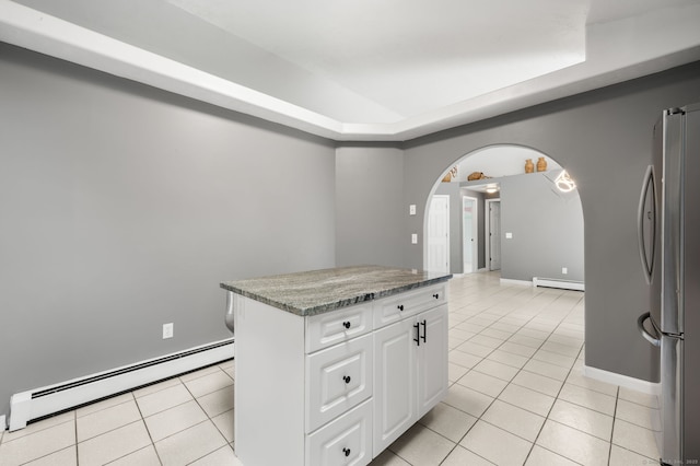 19 Peach Tree Hill Ave, Ledyard, CT 06339 - kitchen with baseboard heating, freestanding refrigerator, light tile patterned floors, and arched walkways