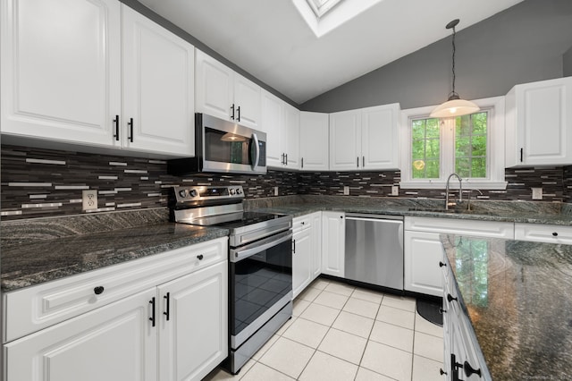 19 Peach Tree Hill Ave, Ledyard, CT 06339 - kitchen with stainless steel appliances, light tile patterned floors, lofted ceiling, white cabinets, and tasteful backsplash