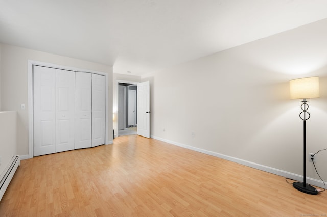 19 Peach Tree Hill Ave, Ledyard, CT 06339 - unfurnished bedroom featuring baseboard heating, light wood finished floors, and a closet