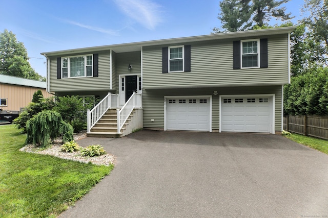 221 Griffin Rd, Suffield, CT 06093 - bi-level home with asphalt driveway and an attached garage