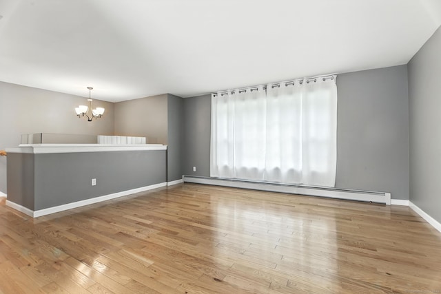 221 Griffin Rd, Suffield, CT 06093 - spare room with a baseboard heating unit, a chandelier, and wood finished floors