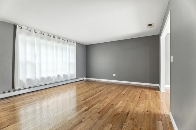 221 Griffin Rd, Suffield, CT 06093 - empty room with baseboard heating and wood finished floors