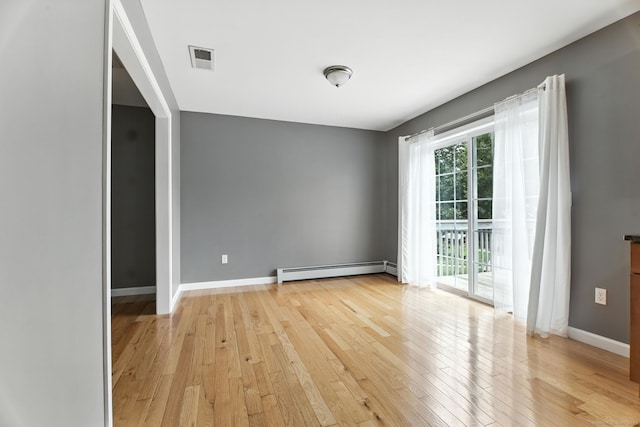 221 Griffin Rd, Suffield, CT 06093 - empty room with baseboard heating and light wood-style floors