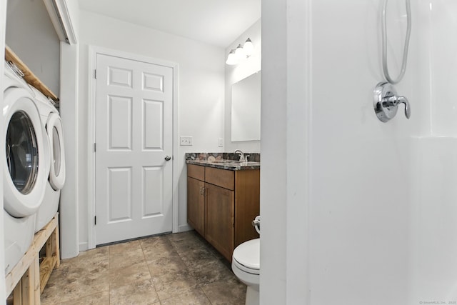 221 Griffin Rd, Suffield, CT 06093 - full bathroom with vanity, stone finish flooring, and washer / clothes dryer