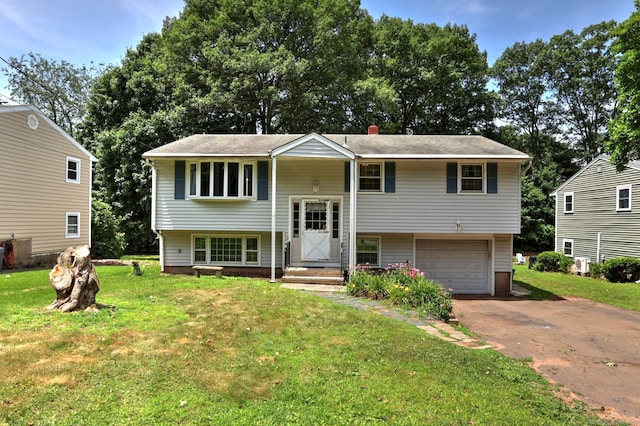 68 Highland Ave, East Haven, CT 06513 - bi-level home with driveway, a front lawn, and an attached garage