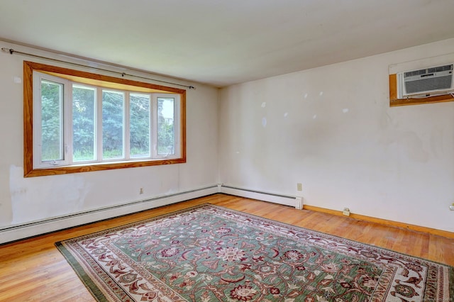 68 Highland Ave, East Haven, CT 06513 - spare room with wood finished floors, an AC wall unit, and a baseboard heating unit