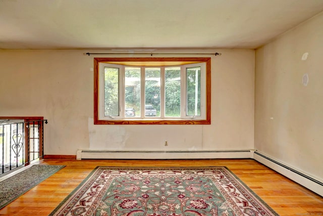 68 Highland Ave, East Haven, CT 06513 - spare room featuring wood finished floors and a baseboard heating unit