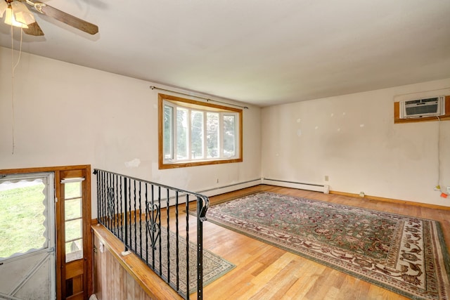 68 Highland Ave, East Haven, CT 06513 - empty room with a wall unit AC, wood finished floors, and a ceiling fan