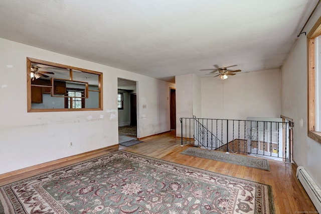 68 Highland Ave, East Haven, CT 06513 - empty room featuring a baseboard heating unit, wood finished floors, and ceiling fan