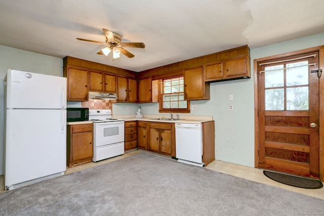 68 Highland Ave, East Haven, CT 06513 - kitchen featuring white appliances, brown cabinets, under cabinet range hood, and light countertops