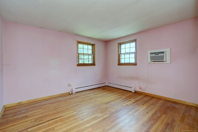 68 Highland Ave, East Haven, CT 06513 - spare room featuring light wood finished floors, a wall mounted air conditioner, and baseboard heating