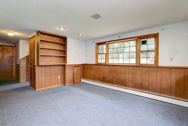 68 Highland Ave, East Haven, CT 06513 - carpeted spare room featuring a baseboard radiator, a wainscoted wall, and wood walls