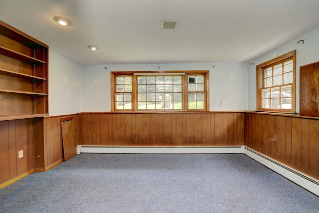 68 Highland Ave, East Haven, CT 06513 - carpeted spare room featuring a wainscoted wall, wood walls, and a baseboard radiator
