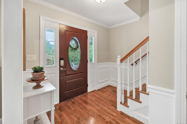 84 Edison Ave, Fairfield, CT 06825 - entrance foyer featuring light wood finished floors, stairway, crown molding, a decorative wall, and wainscoting