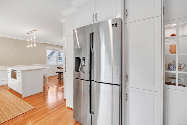 84 Edison Ave, Fairfield, CT 06825 - kitchen with stainless steel fridge with ice dispenser, ornamental molding, white cabinetry, light wood finished floors, and hanging light fixtures