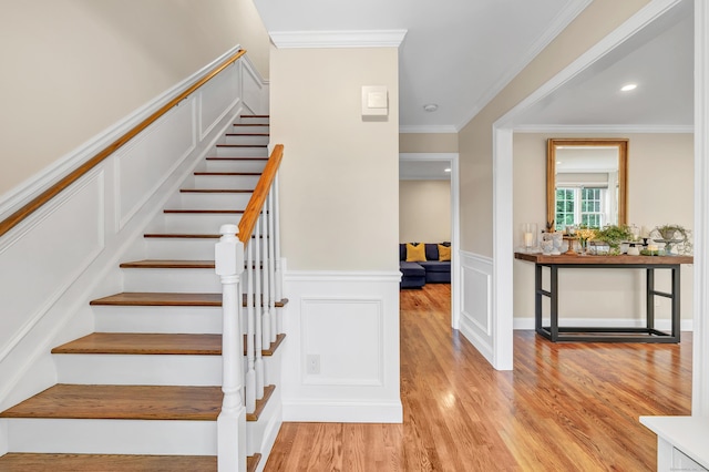 84 Edison Ave, Fairfield, CT 06825 - stairway with wood finished floors, wainscoting, a decorative wall, ornamental molding, and recessed lighting