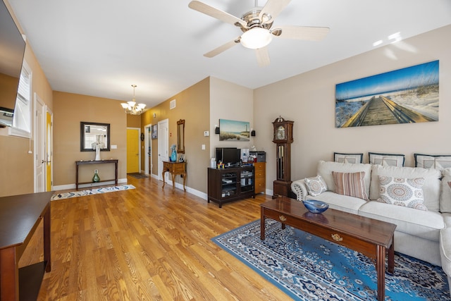 79 Orland St, Milford, CT 06460 - living room with a chandelier, light wood-type flooring, and a ceiling fan
