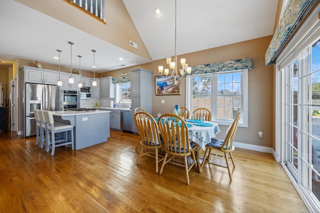 79 Orland St, Milford, CT 06460 - dining space with a chandelier, light wood finished floors, high vaulted ceiling, and recessed lighting