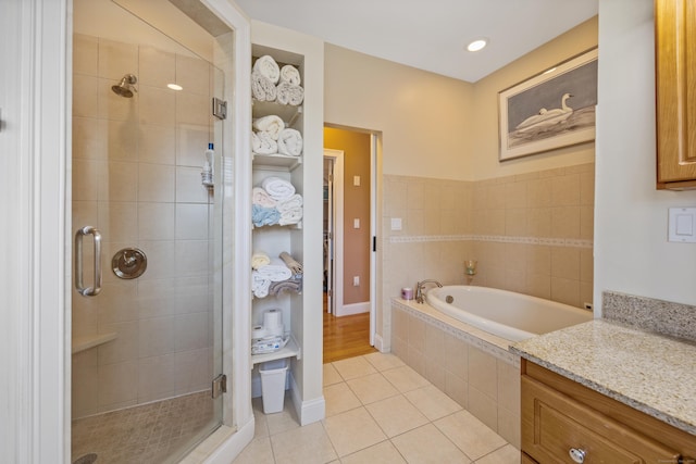 79 Orland St, Milford, CT 06460 - full bath featuring tile patterned floors, a shower stall, a garden tub, and vanity